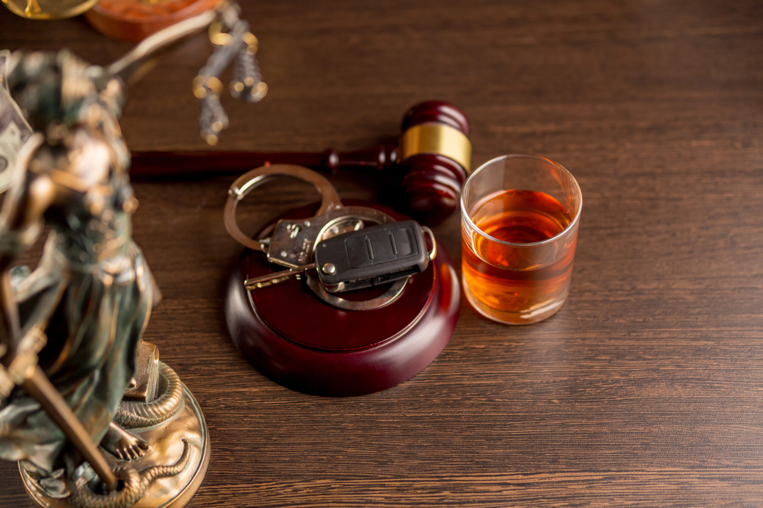 Michigan driver's license and gavel representing DUI defense and license suspension hearings in Lansing