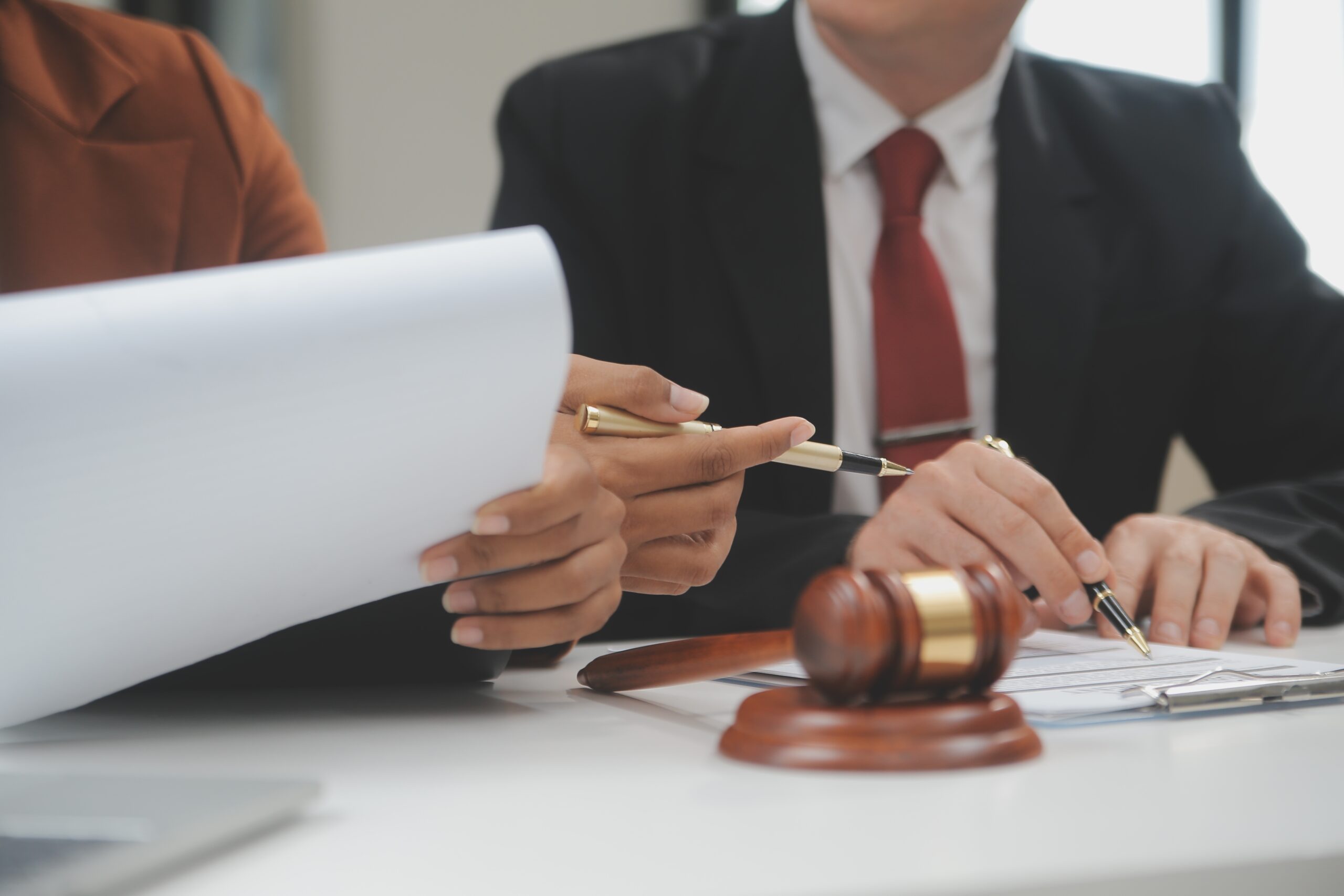 Lansing reckless driving lawyer reviewing traffic case documents with client